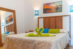 a bedroom with two swans on a bed at Los Marineros in Gran Tarajal