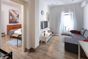 a living room with a couch and a bed at Apartment FERIA 2 in Opatija