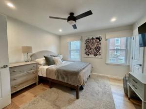 a bedroom with a bed and a ceiling fan at Perfect WFH Fishtown Townhouse with Private Patio in Philadelphia