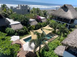 an aerial view of a resort with a swimming pool and the ocean at Ka´ana Surf in El Paredón Buena Vista