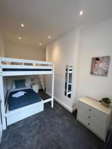 a bedroom with a bunk bed and a dresser at Amazing One Bed Flat West Hampstead in London