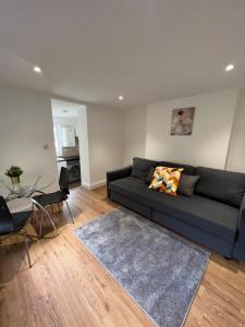 a living room with a couch and a table at Amazing One Bed Flat West Hampstead in London