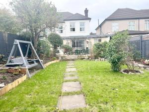 a backyard with a garden with a swing at 4 Bed house in Daneby Road,SE6 in Catford