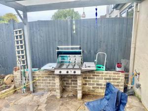 a grill on a brick wall in front of a fence at 4 Bed house in Daneby Road,SE6 in Catford