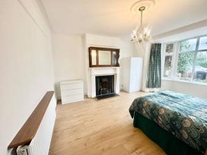 a bedroom with a bed and a fireplace at 4 Bed house in Daneby Road,SE6 in Catford