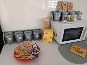 a microwave sitting on top of a counter with food at Apartman Cirkic in Sanski most +29 photos