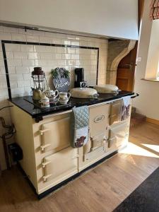a kitchen with a stove top oven in a room at Gortaclare Lodge 