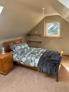 a bedroom with a bed and a window at Gortaclare Lodge 