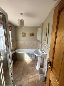 a bathroom with a sink and a bath tub at Gortaclare Lodge 