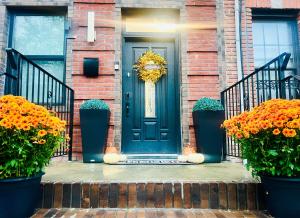 a blue front door of a brick house with flowers at 2 Bedroom Apartment, Close to NYC & Downtown JC! in Jersey City