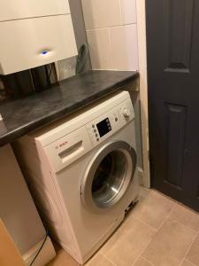 a washing machine in a kitchen with a counter at Denis in Lincoln