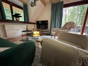 - un salon avec un canapé, des chaises et une télévision dans l'établissement Vakantiewoning Waag, à Rekem