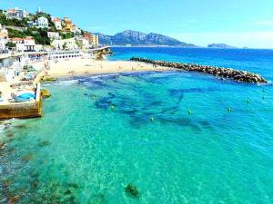 an aerial view of a beach with people in the water at *Le Royal*Havre De Paix*Wifi* in Marseille