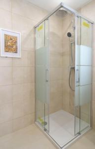 a shower with a glass door in a bathroom at Casa SP- Villa with heated pool near Vilamoura, Vale do Lobo in Quarteira