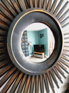 a circular mirror in front of a living room at Driftwood Apartment in Saltburn-by-the-Sea
