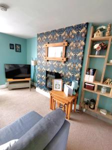 a living room with a couch and a table at Driftwood Apartment in Saltburn-by-the-Sea