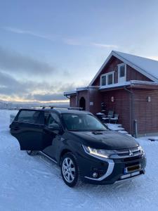 a black car parked in front of a house at 3ART recreation in Tromsø