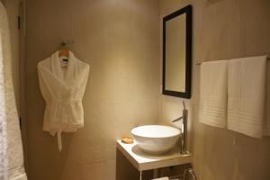 a bathroom with a white sink and a mirror at Sala Boutique Hotel in Male City