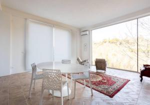 ein Esszimmer mit einem weißen Tisch und Stühlen in der Unterkunft Depandance holiday Villa, garden and privat pargking in Perugia