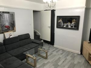 a living room with a couch and a fireplace at Rose Cottage in Tipton