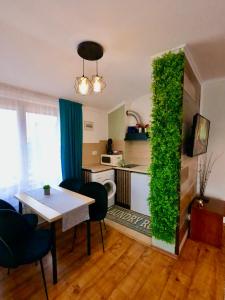 a living room with a table and a green wall at Mountain Home in Bansko