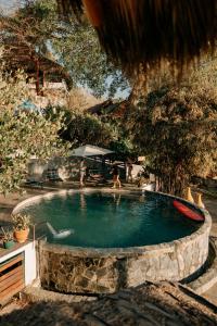 a swimming pool with people sitting around it at Hotel Maraica San Pancho in San Francisco