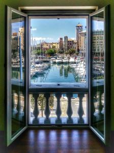 a window with a view of a marina at Vista sulla marina, AC, ascensore in Savona
