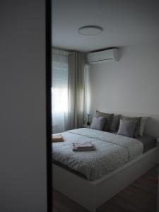 a bedroom with a large bed with a window at Apartment Simon in Zagreb