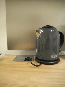 a toaster sitting on top of a wooden table at Apartment Simon in Zagreb
