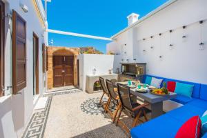 A television and/or entertainment centre at Lindos Allure Villa with Jacuzzi and Acropolis view!!!