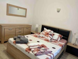 a bedroom with a bed with towels on it at GEORGIANA in Buzău +1 photo