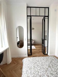 a white room with a mirror and a bed at Old Town Residence , Wi-fi , 2-Beds , Aesthetics - by HIK Apartments in Warsaw