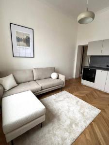 a living room with a couch and a rug at Old Town Residence , Wi-fi , 2-Beds , Aesthetics - by HIK Apartments in Warsaw
