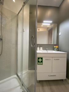 a bathroom with a shower and a sink at Urban 44 Guest House in Ponta Delgada