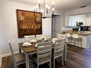 威尼斯的住宿－New! Fully Renovated 3/2 Luxury Vacation Home，用餐室以及带桌椅的厨房。