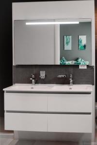 a bathroom with a white sink and a mirror at Flora Fauna 84 Aruba Apartment in Palm-Eagle Beach