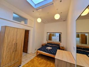 a bedroom with a bed and a skylight at 4 Bedroom 3 Bathroom Central House by Tube Station in London