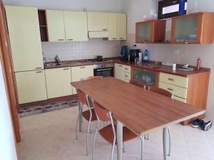 a kitchen with a wooden table and chairs at Residence Artemide 5° in Isernia +9 photos