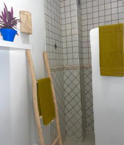 a bathroom with two wooden chairs next to a refrigerator at Dar Lahlou in Tangier