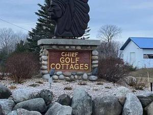 a sign for a gift golf courses with a lion statue at Spacious condo for 6 on Golf course, Pool Pass in Bellaire