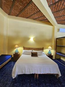 a bedroom with a large white bed with two lamps at Villa Corona del Mar in Rincon de Guayabitos +15 photos