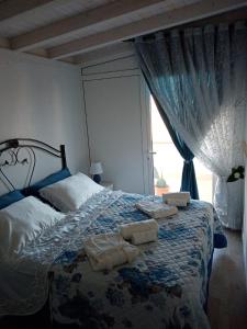 a bedroom with a bed with towels on it at La Terrazza Solarium in Santa Flavia