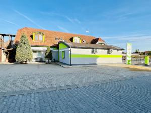 a house with a brick road in front of it at Penzión Tyché in Šurany