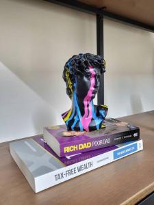 a statue sitting on top of three books on a table at 'TheFive' Camden Town in London