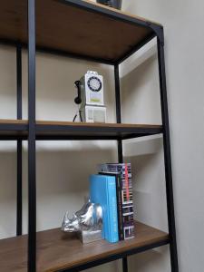 a shelf with a clock and books on it at 'TheFive' Camden Town in London