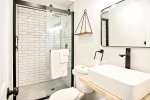 a bathroom with a sink and a toilet and a shower at Chic & Cozy Retreat For Romantic Spring Getaways in Oklahoma City