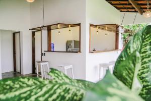 a room with a table and chairs and mirrors at Casas Oceanicas in Icaraí