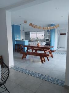 a living room with a wooden table and a kitchen at Quinta EL SECRETO in Olavarría