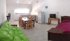 a kitchen and a living room with a table and a dining room at Complejo Bru-Mar in Los Olivares