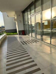 an empty lobby of a building with glass doors at Boutique Apartment in Bucharest